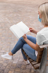 Female With Mask On Street Reading Book Psd