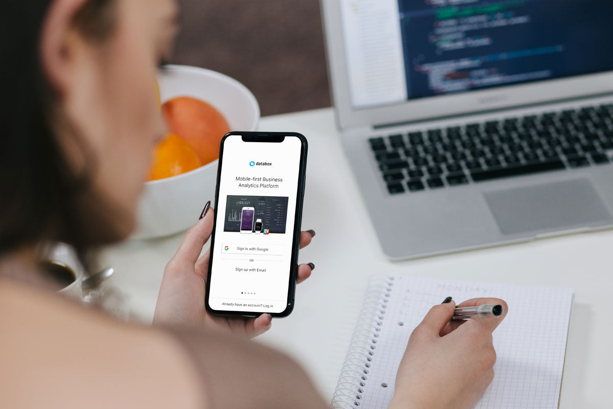 Woman Holding iPhone X Mockup and Taking Notes