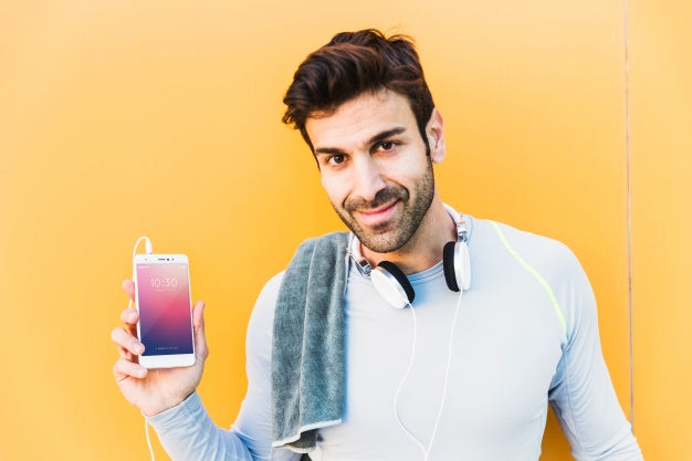 Fitness Mockup With Man Showing Smartphone Psd