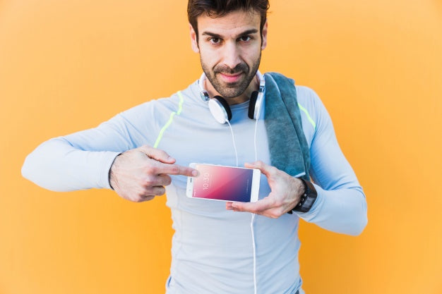 Fitness Mockup With Man Showing Smartphone Psd