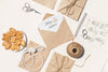 Flat Lay Arrangement Of Brown Paper Envelopes And Wedding Rings Psd