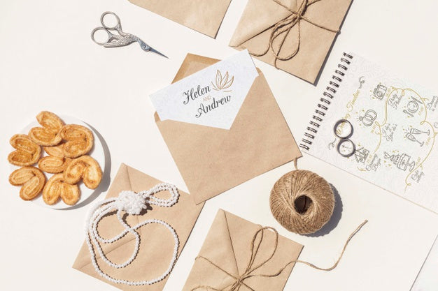 Flat Lay Arrangement Of Brown Paper Envelopes And Wedding Rings Psd