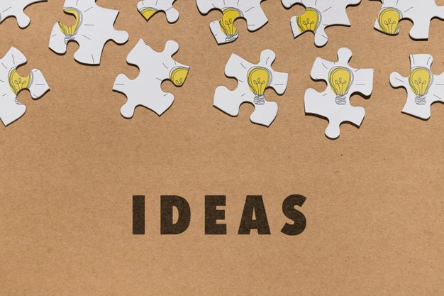 Flat Lay Arrangement With Puzzle Pieces On Brown Background Psd