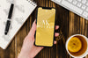Flat Lay Hand Holding Smartphone Mock-Up With Tea On Desk Psd
