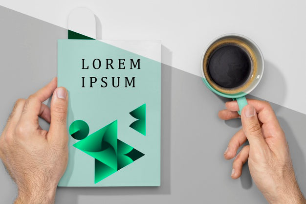 Flat Lay Hands Holding Book Mock-Up And Coffee Psd