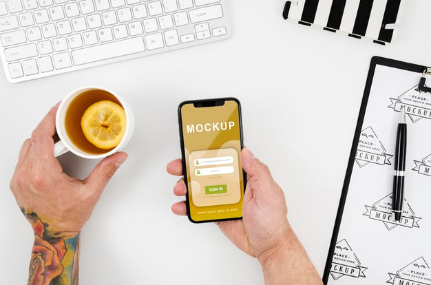 Flat Lay Hands Holding Smartphone Mock-Up And Tea Psd