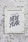 Flat Lay New Year Lettering On Frame Mock-Up With Confetti Psd