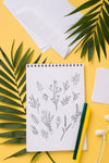 Flat Lay Notebook Mock-Up And Pen Near With Tropical Leaves Psd