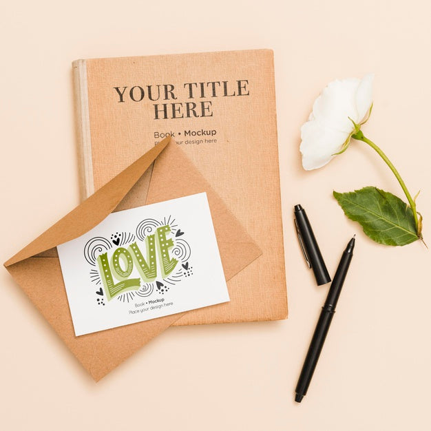 Flat Lay Of Book With Flower And Card Psd