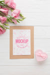 Flat Lay Of Card With Pink Roses Psd