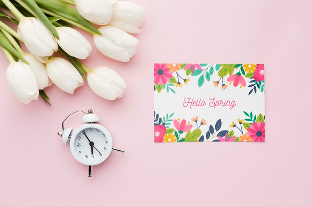 Flat Lay Of Card With Tulips And Clock Psd