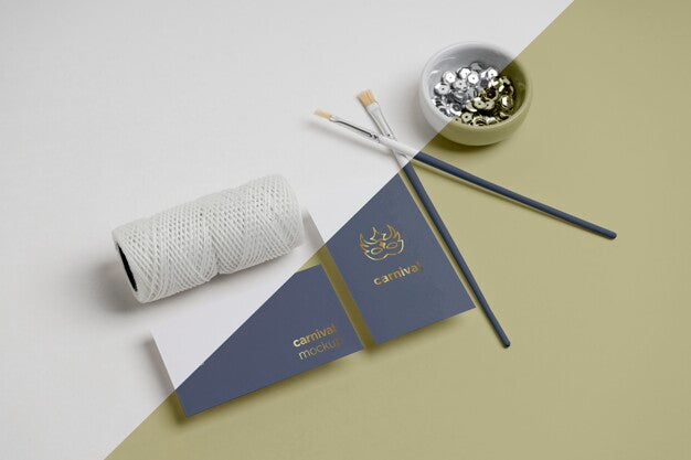 Flat Lay Of Carnival Invitation With Paint Brushes And Beads Psd