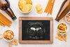 Flat Lay Of Chalkboard With Beer Bottles And Assortment Of Snacks Psd