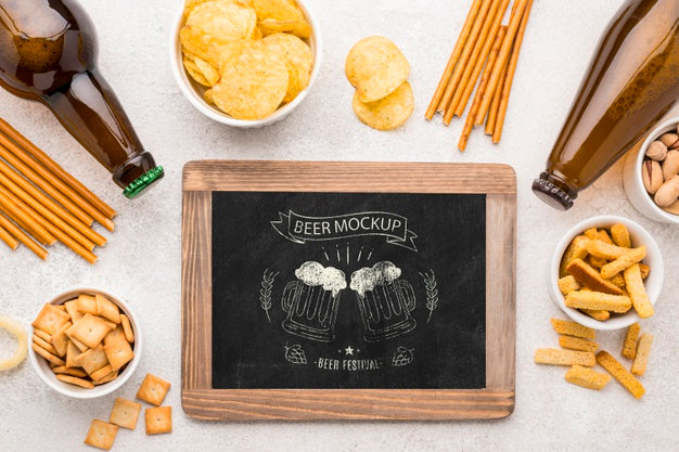 Flat Lay Of Chalkboard With Beer Bottles And Assortment Of Snacks Psd