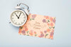 Flat Lay Of Clock And Floral Card For Spring Psd