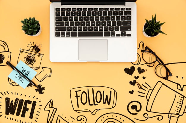 Flat Lay Of Desk Surface With Laptop And Plants Psd