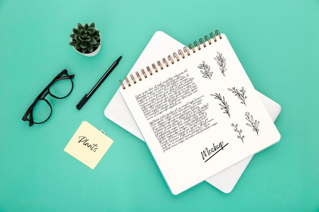 Flat Lay Of Desk Surface With Notebook And Glasses Psd