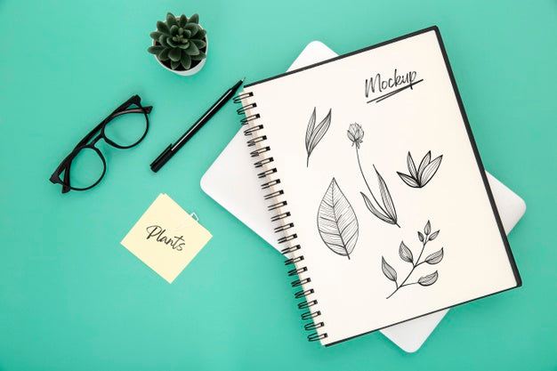 Flat Lay Of Desk Surface With Notebook And Pen Psd