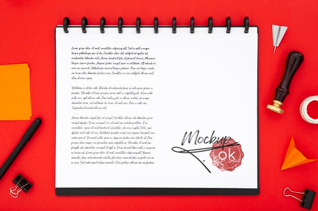 Flat Lay Of Desk Surface With Notebook And Seal Psd