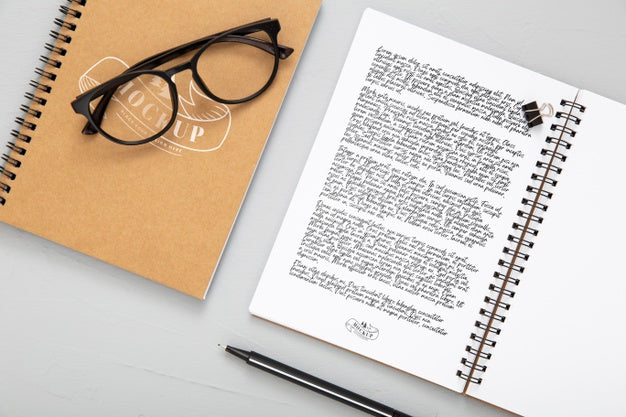 Flat Lay Of Desk Surface With Notebooks And Glasses Psd