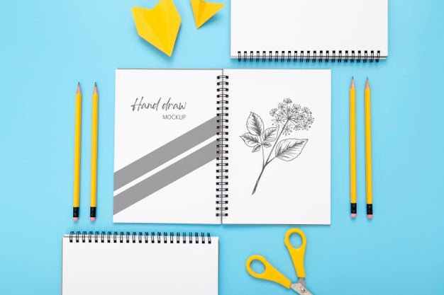 Flat Lay Of Desk Surface With Notebooks And Pencils Psd