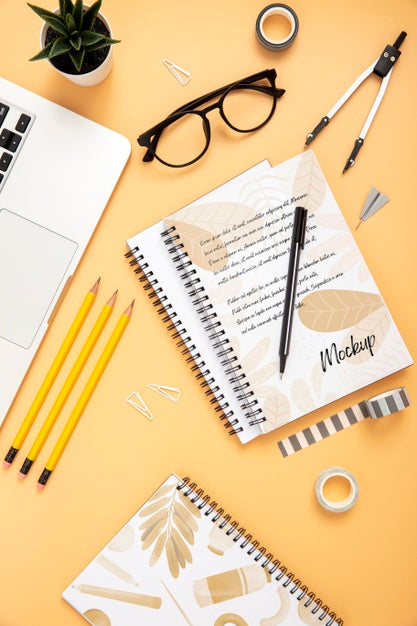 Flat Lay Of Desk Surface With Notebooks And Succulent Psd