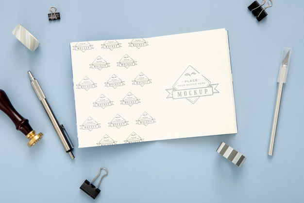Flat Lay Of Desk Surface With Notepad And Pen Psd