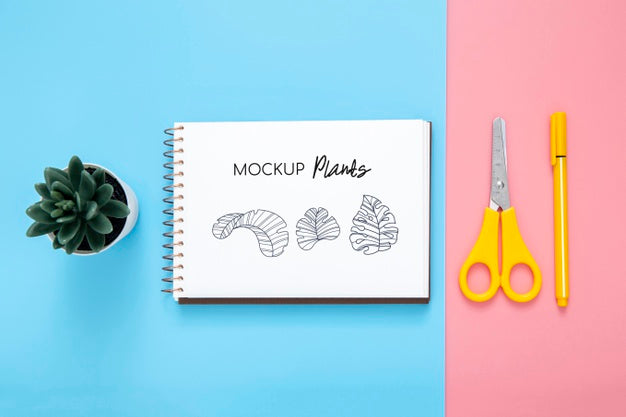 Flat Lay Of Desk Surface With Notepad And Scissors Psd