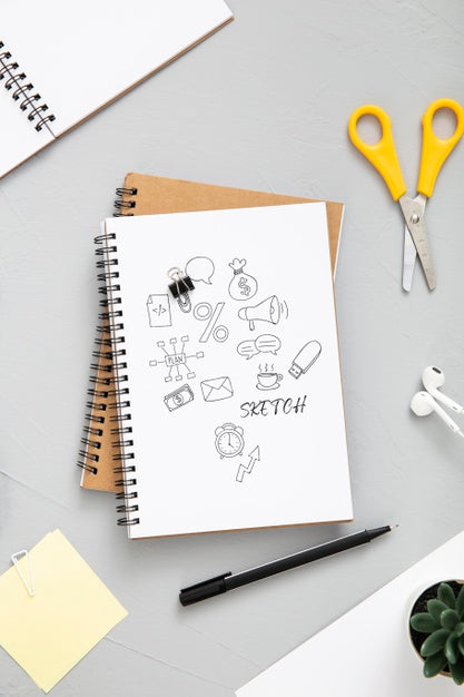 Flat Lay Of Desk Surface With Scissors And Notepad Psd