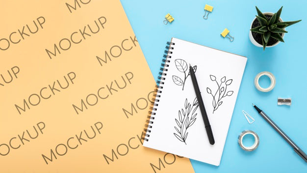 Flat Lay Of Desk Surface With Succulent And Notebook Psd