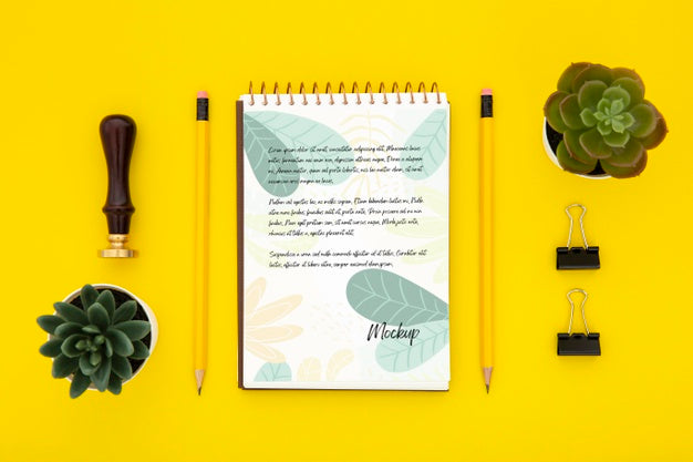 Flat Lay Of Desk Surface With Succulents And Notebook Psd
