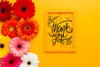 Flat Lay Of Frame And Flowers On Yellow Background Psd