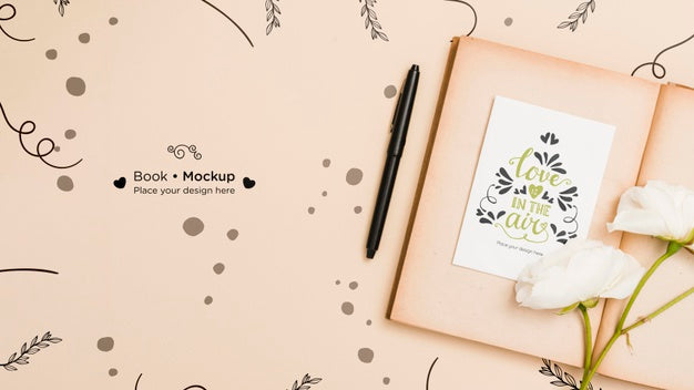 Flat Lay Of Open Book With Roses And Pen Psd
