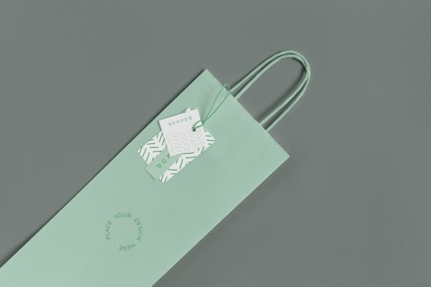 Flat Lay Of Paper Shopping Bag Mock-Up With Paper Tag Psd