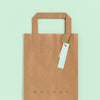 Flat Lay Of Paper Shopping Bag Mock-Up With Paper Tag Psd
