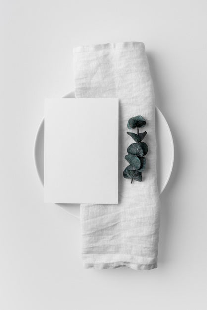 Flat Lay Of Table Arrangement With Spring Menu Mock-Up And Towel On Plate Psd