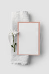 Flat Lay Of Table Arrangement With Spring Menu Mock-Up On Towel And Flower Psd