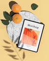 Flat Lay Of Tablet With Photo And Citrus Psd