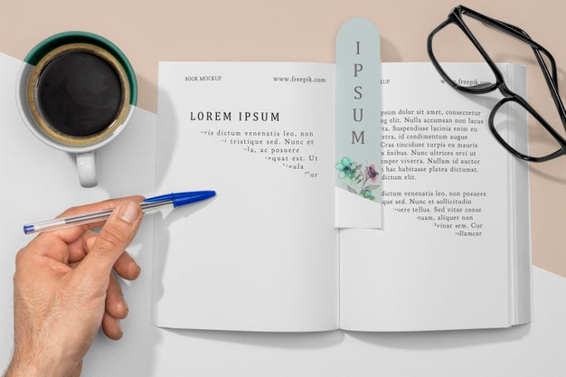 Flat Lay Open Book And Bookmark Mock-Up With Coffee Psd