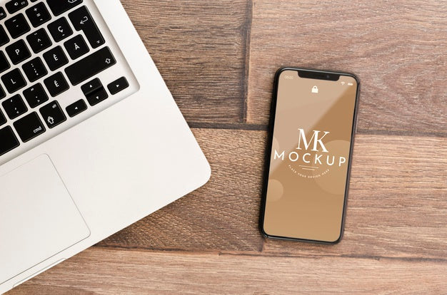 Flat Lay Smartphone Mock-Up With Laptop On Desk Psd