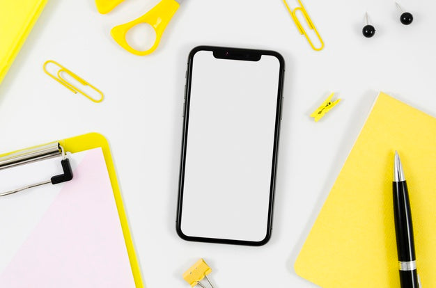 Flat Lay Smartphone Mock-Up With Stationery On Desk Psd