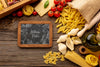 Flat Lay Uncooked Pasta Assortment And Tomatoes With Blackboard Mock-Up Psd