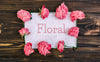 Floral Frame Pink Roses Mockup On Wooden Table Psd