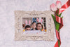 Flowers Beside Frame With Easter Family Photo Psd