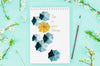 Flowers Beside Notebook With Artistic Draw Psd