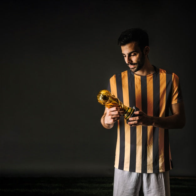 Football Player Looking At Trophy Psd