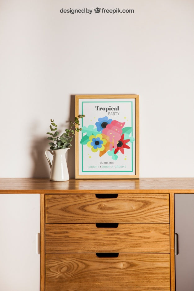 Frame Next To Plant On Desk Psd