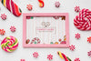 Frame With Tasty Candies Beside Psd
