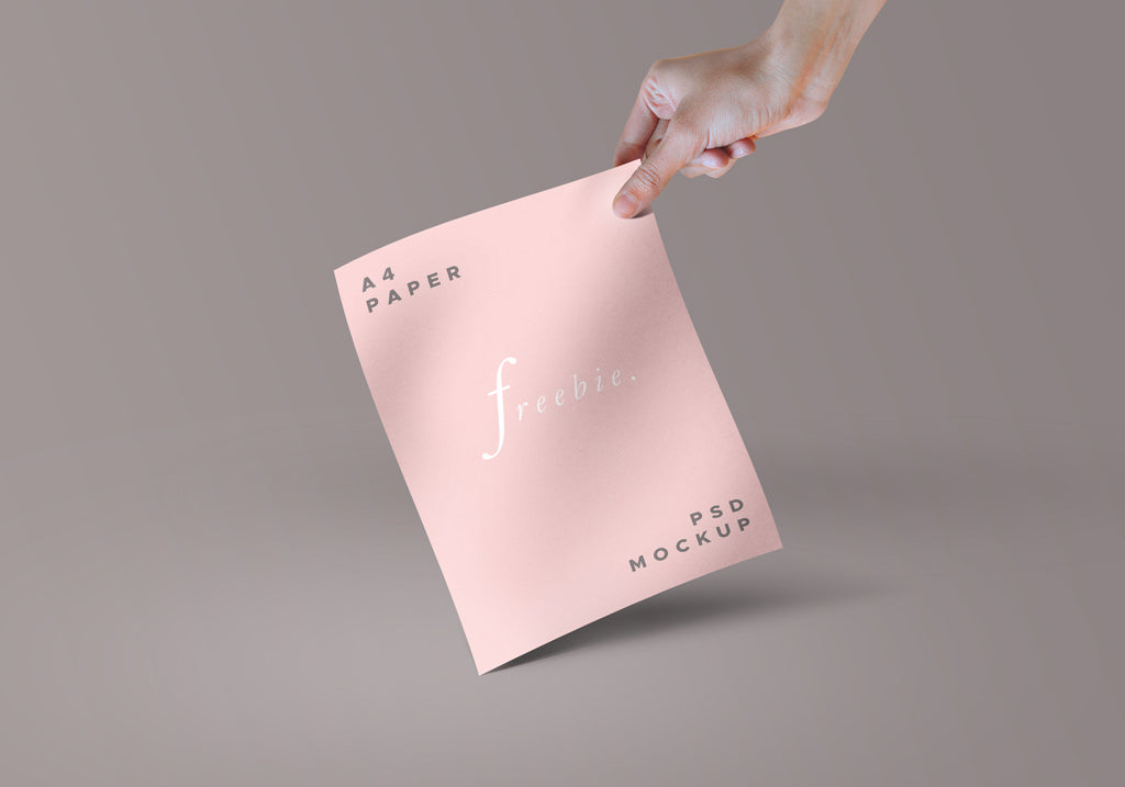 Hand holding Paper or Magazine PSD Mockup