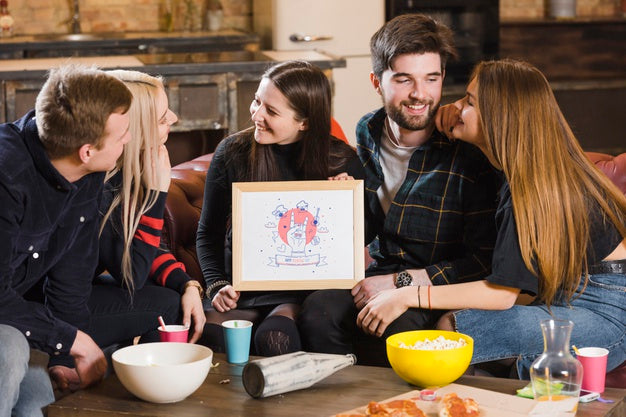 Friends At A Party Holding A Frame Mock-Up Psd